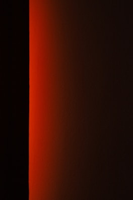 a black and white photo of a red light