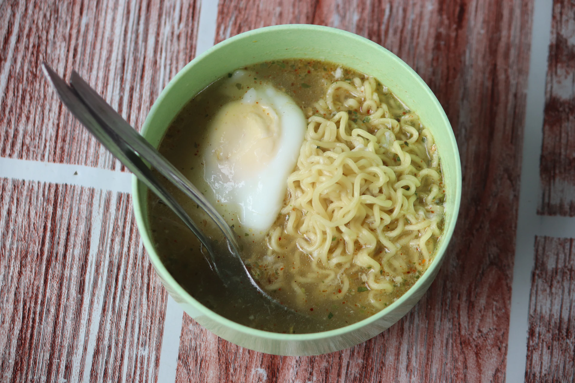 a bowl of ramen with an egg on top