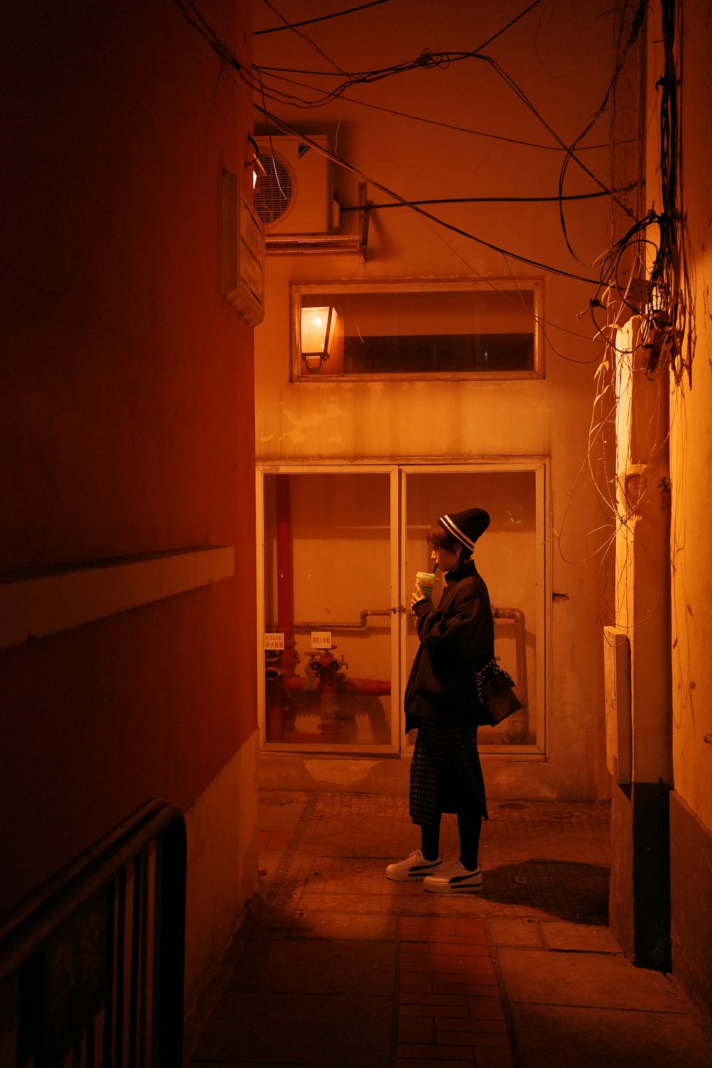 a person standing in an alley way at night