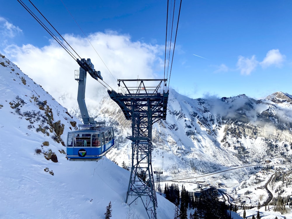 a ski lift going up a snowy mountain