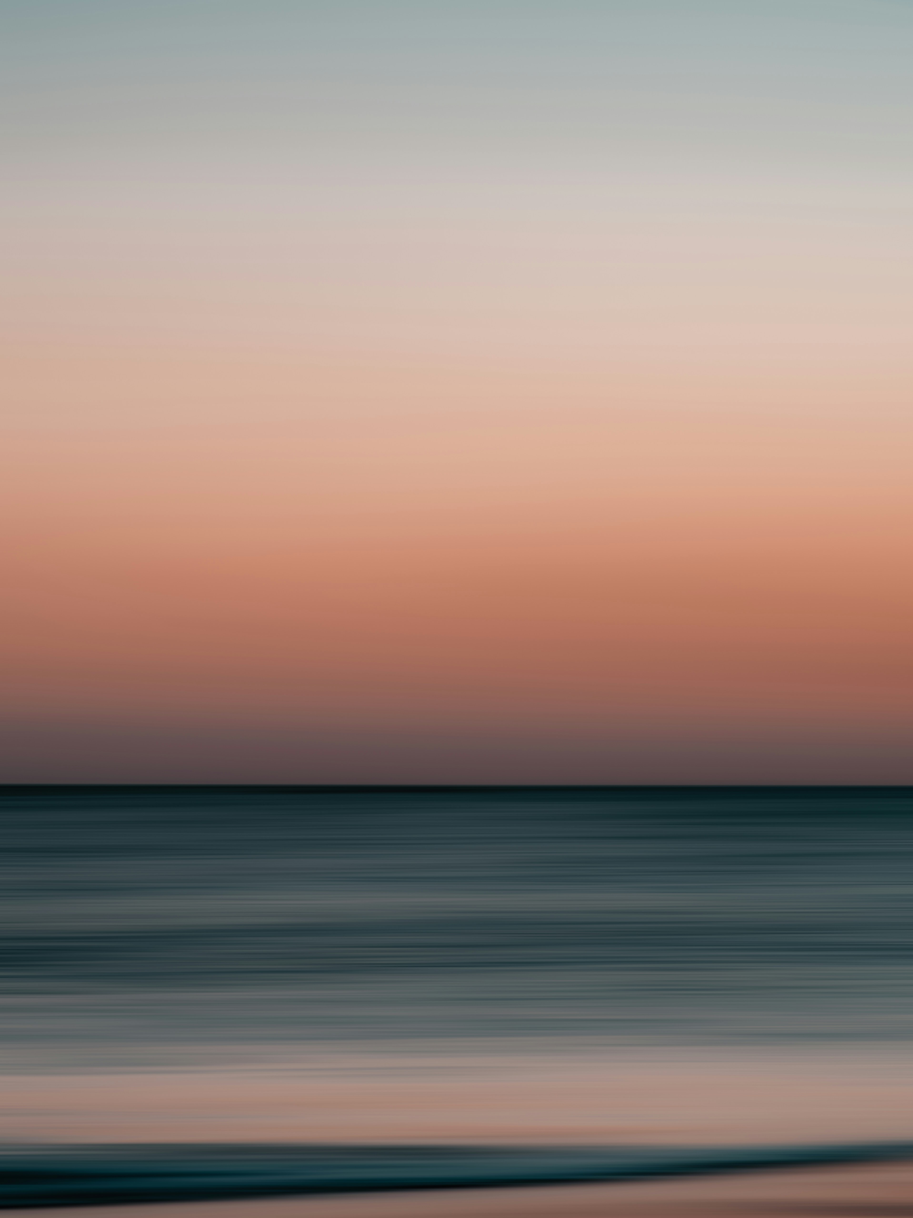 a blurry photo of the ocean at sunset