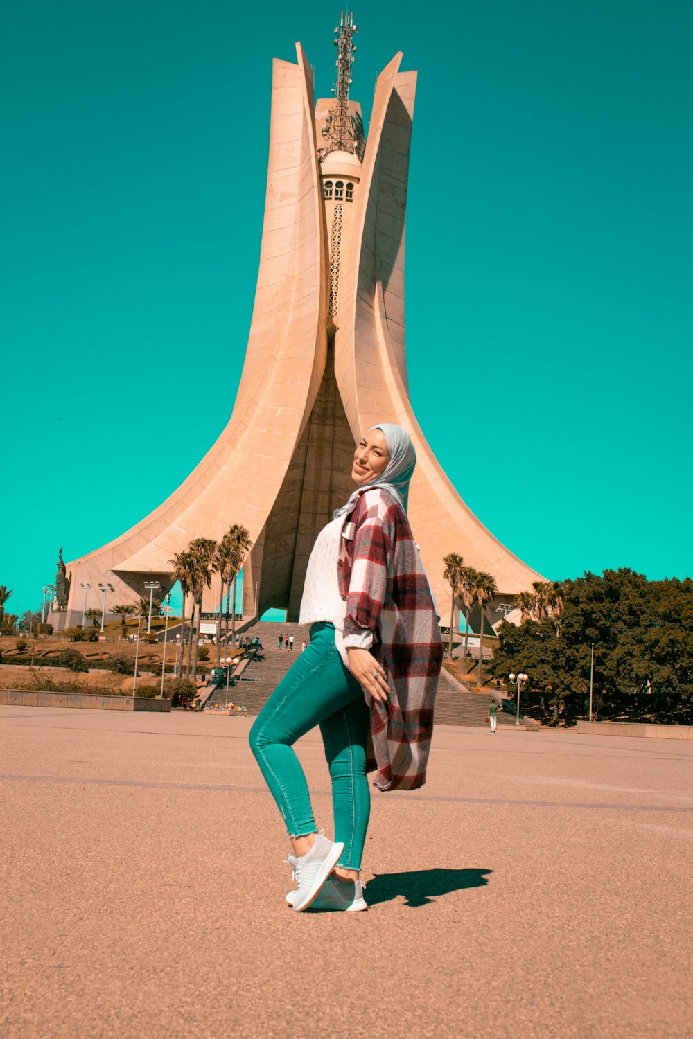 a woman standing in front of a tall building