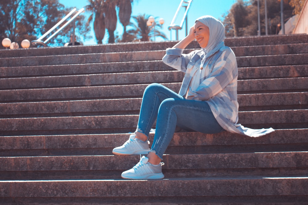 a woman sitting on a set of stairs