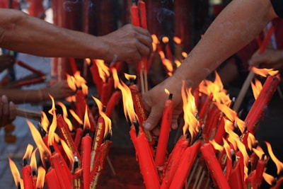 A close-up of hands holding candles during a service.