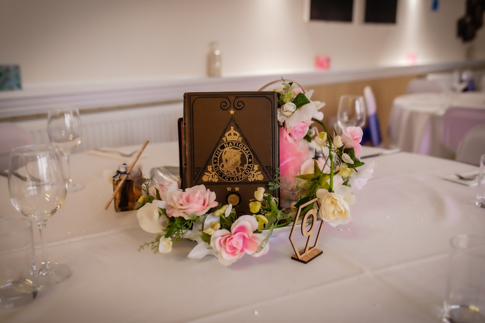 a table with a book and flowers on it