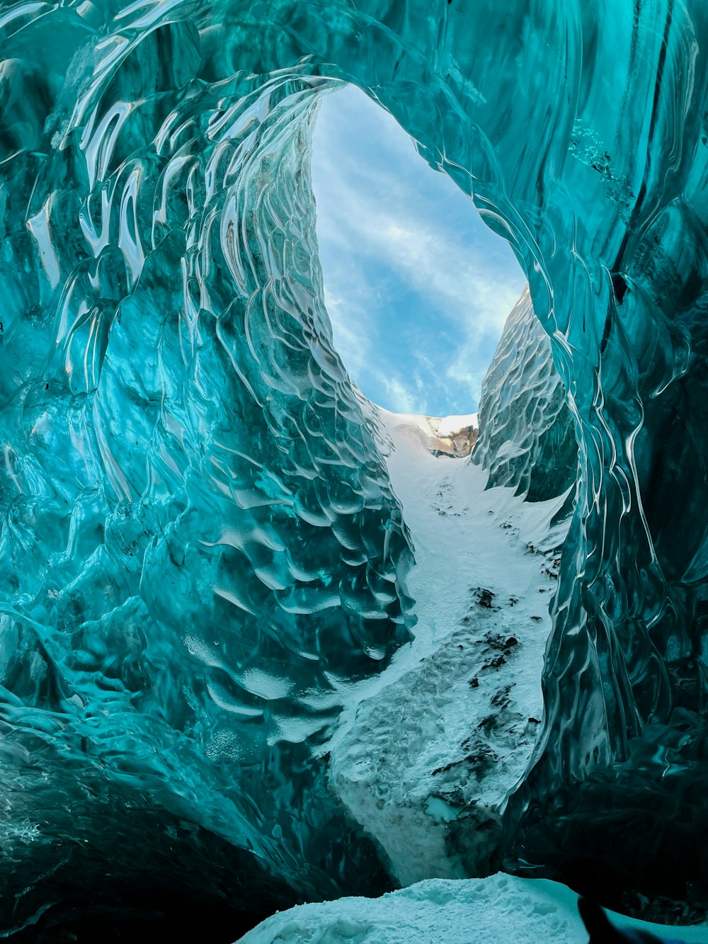 a very large ice cave with a sky background