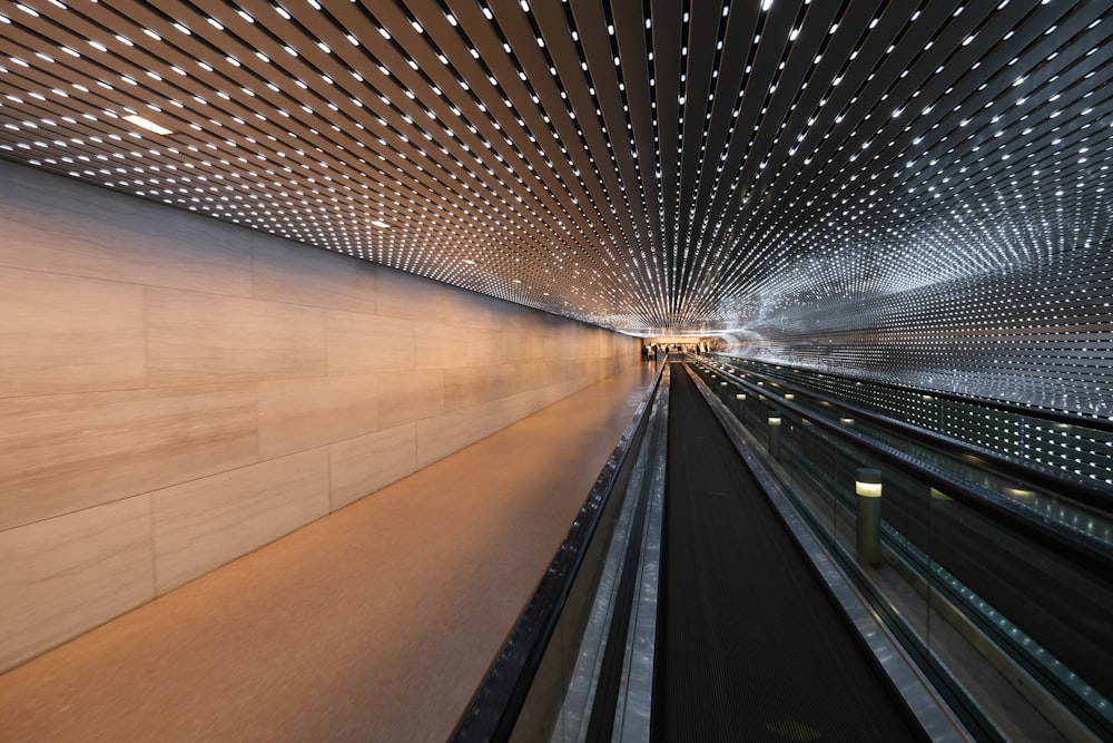 a very long tunnel with lights on the ceiling