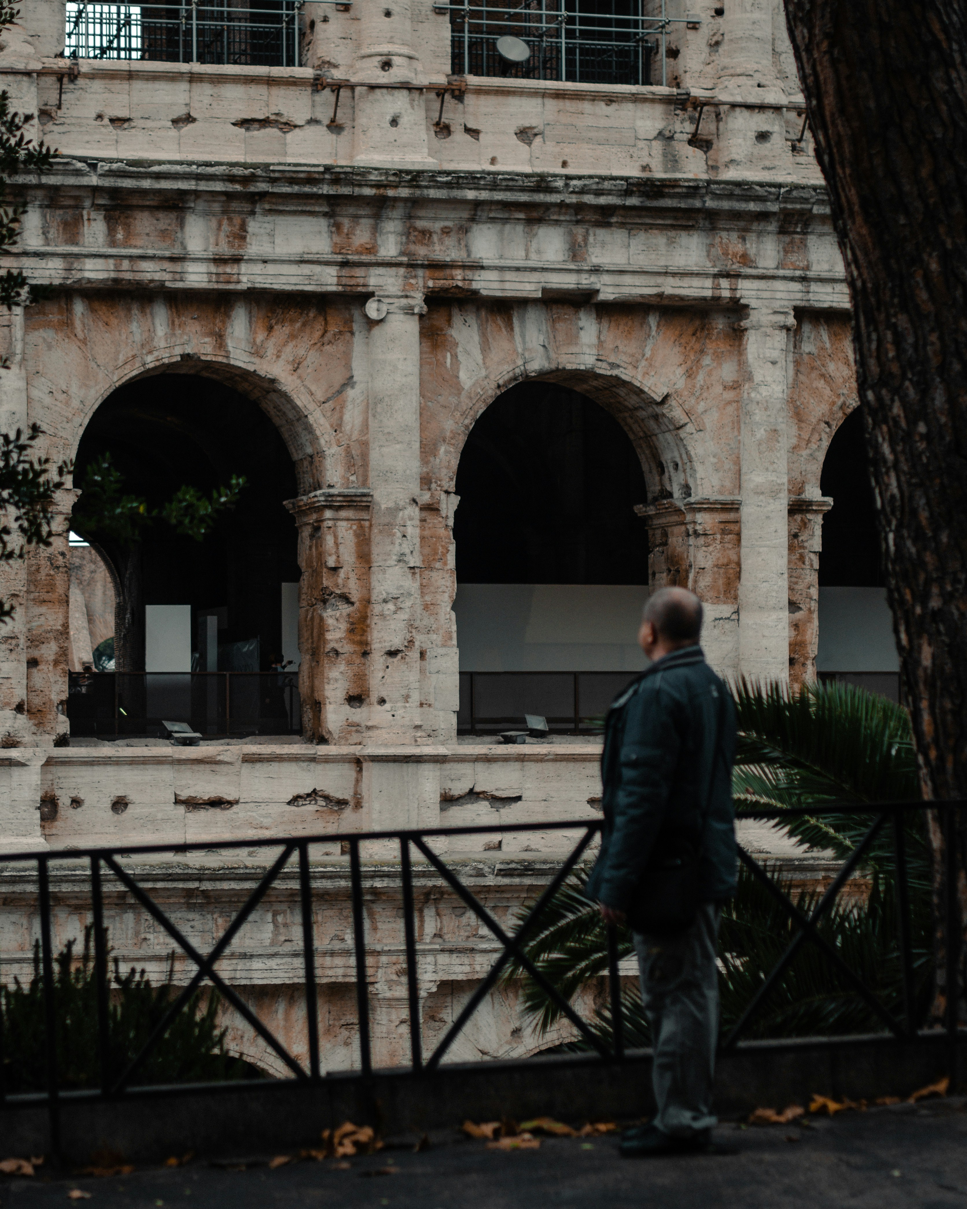 a man standing in front of an old building