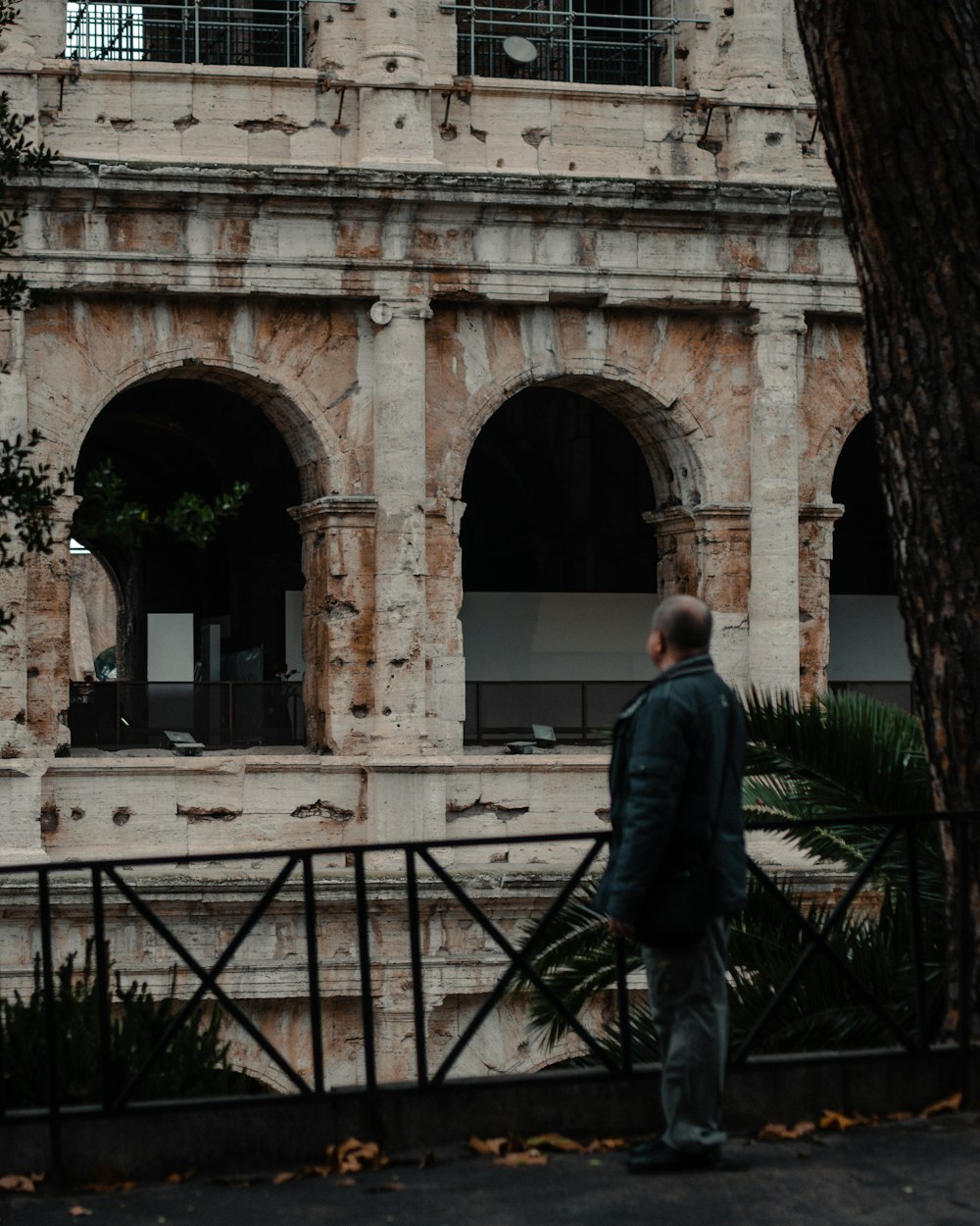 a man standing in front of an old building