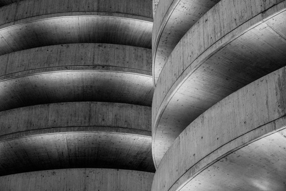 a black and white photo of a curved building