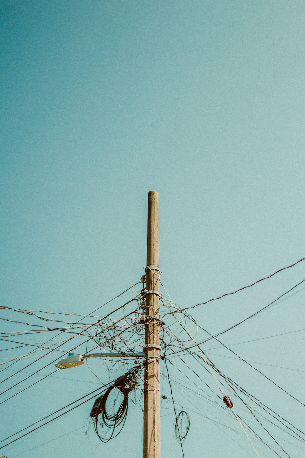 a telephone pole with a bunch of wires attached to it