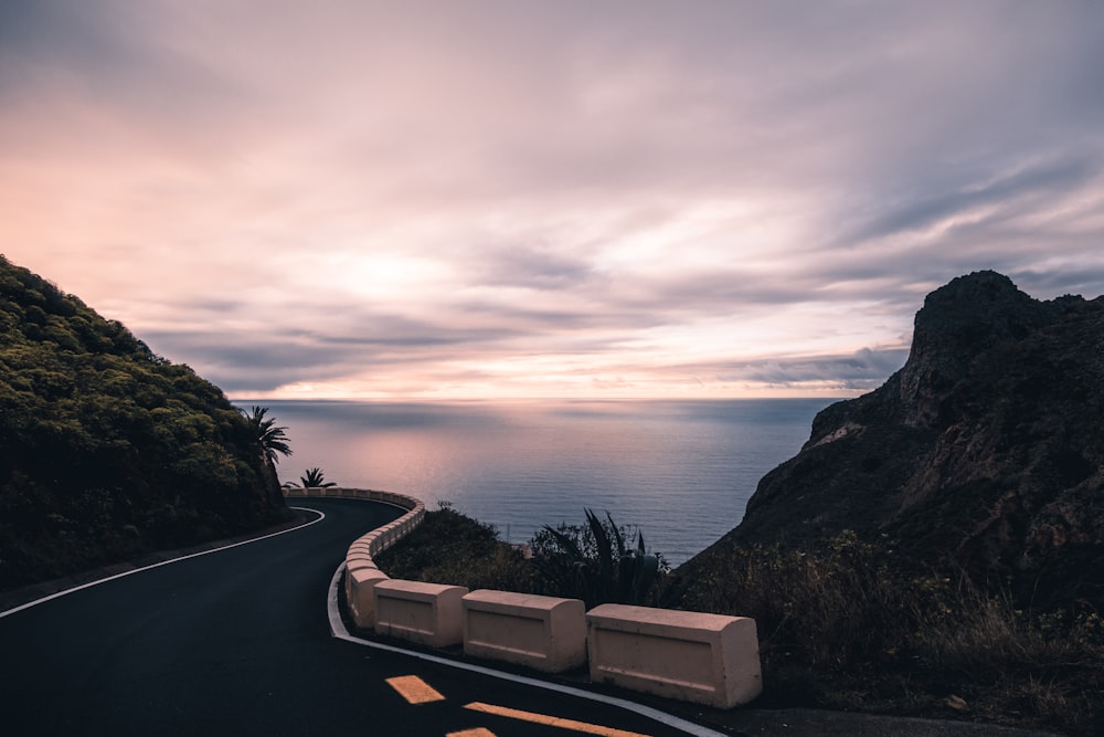 a scenic road with a view of the ocean