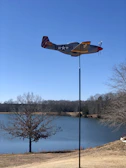 A model RC aircraft in mid-flight against a clear blue sky