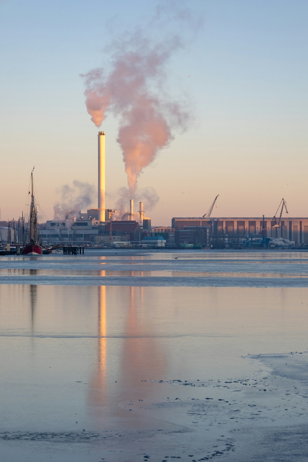 a factory with smoke coming out of it's stacks