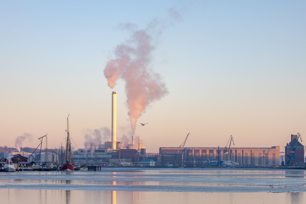 a factory with smoke billowing out of it's stacks