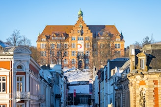 a city street with a large building in the background