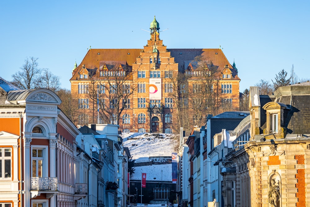 a city street with a large building in the background