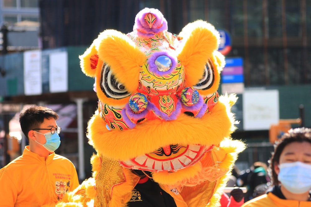 a man wearing a face mask and a dragon costume