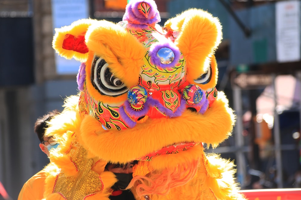 a person in a yellow dragon costume