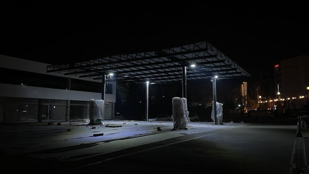 an empty parking lot at night with lights on