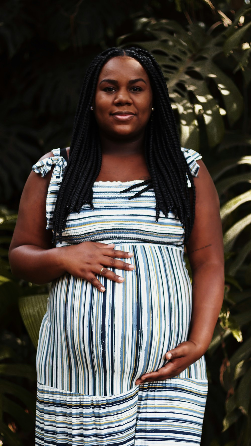 a woman in a striped dress poses for a picture