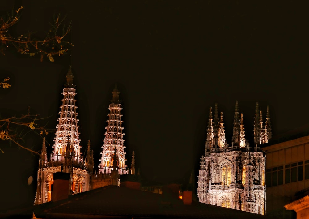 a large cathedral lit up at night with lights on it