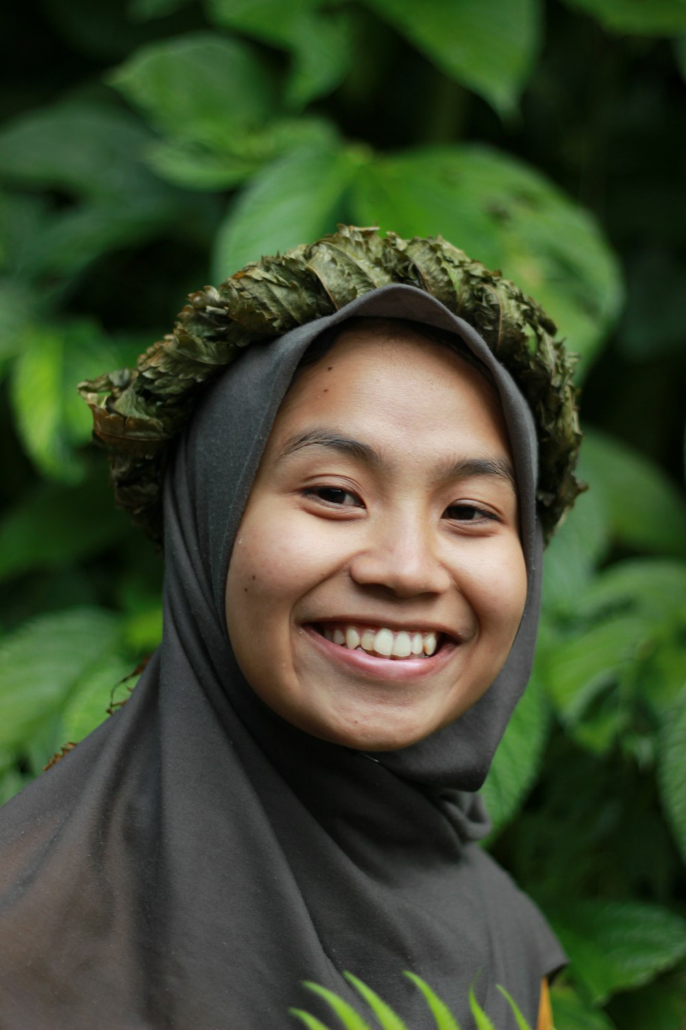 a woman wearing a headscarf smiles for the camera