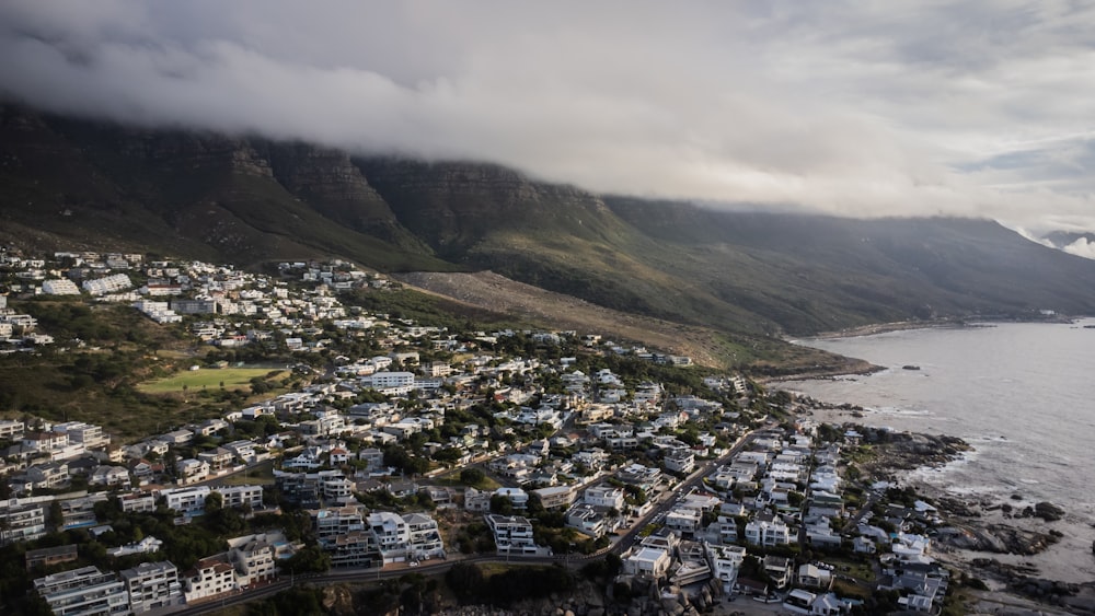 an aerial view of a city with mountains in the background