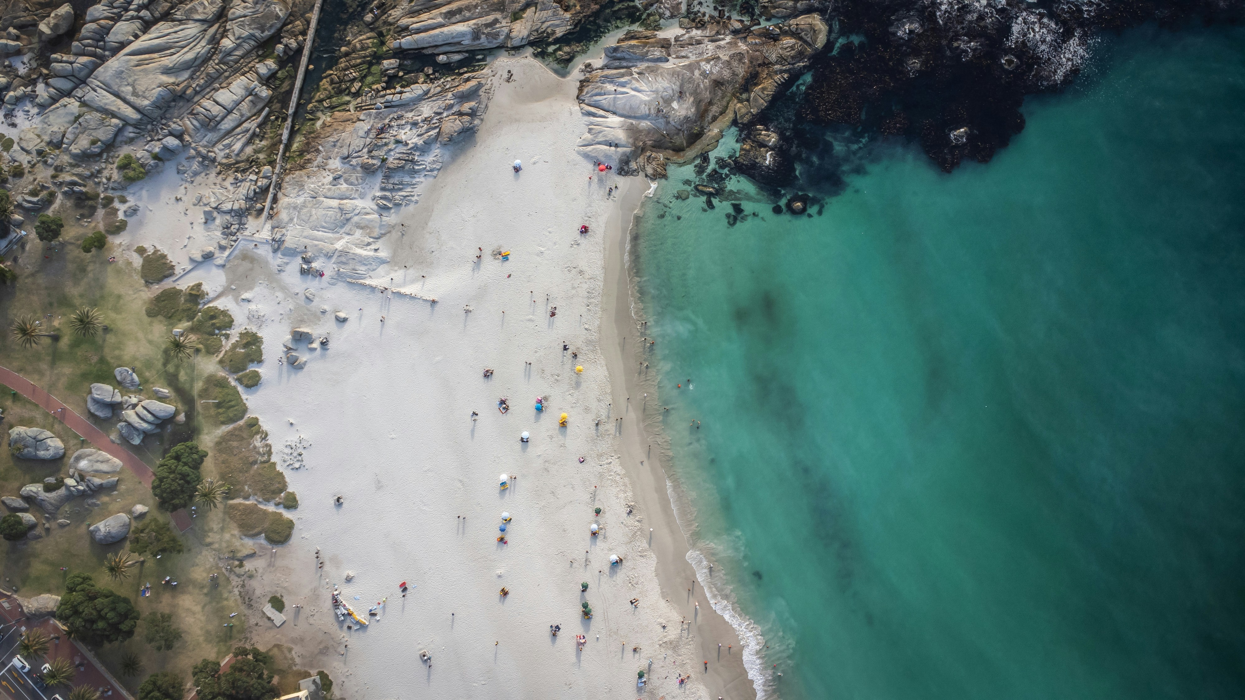 an aerial view of a beach with people on it, Camps Bay beach, Cape Town, South Africa
