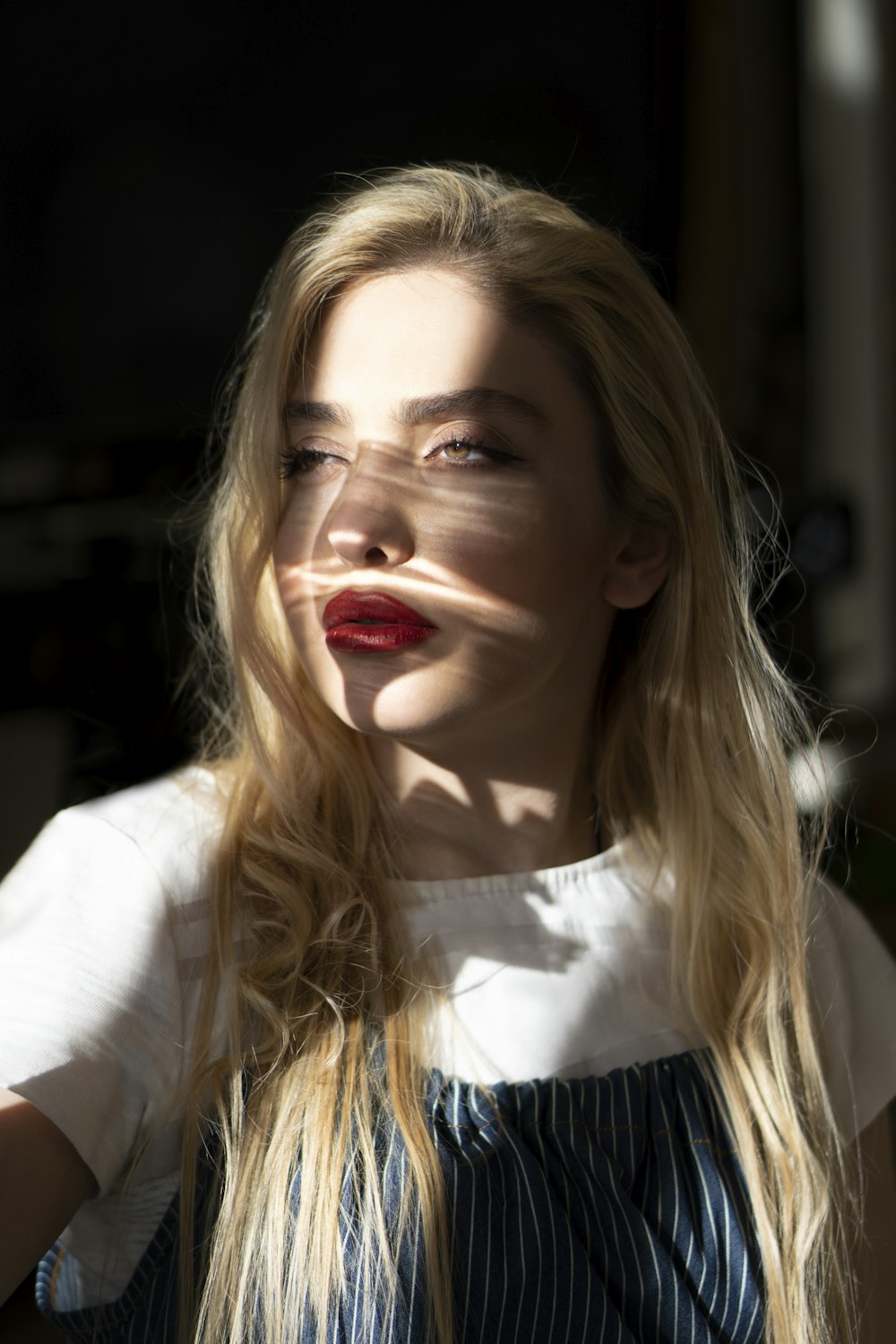 a woman with long blonde hair and red lipstick