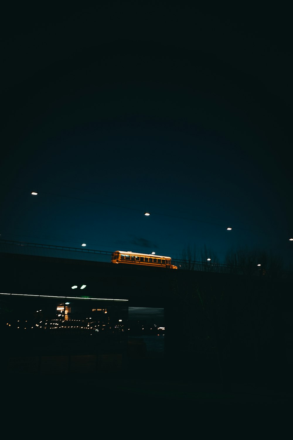 a train traveling over a bridge at night