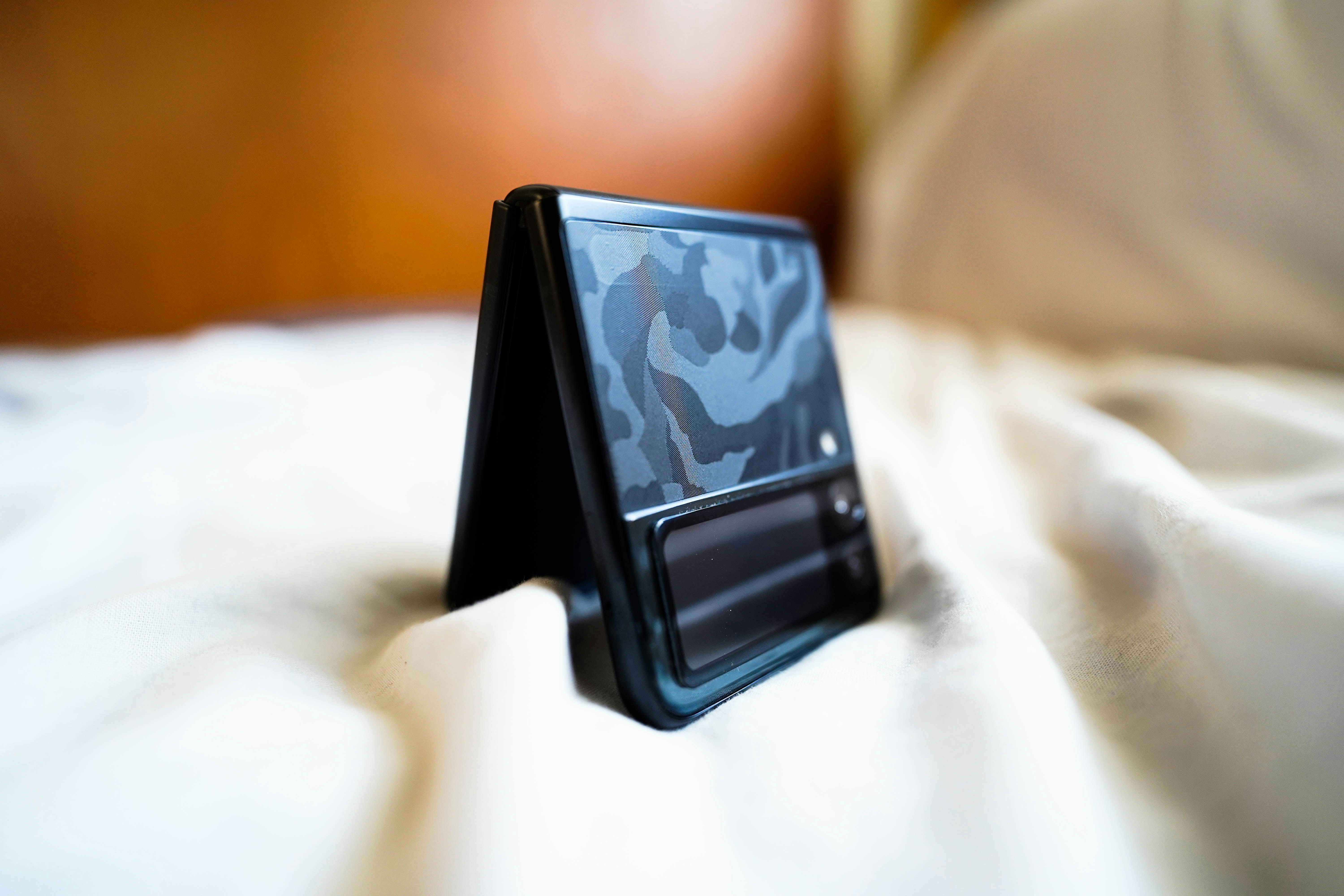 a small tablet sitting on top of a bed