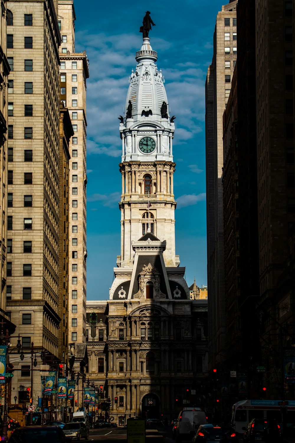 a tall clock tower towering over a city filled with tall buildings