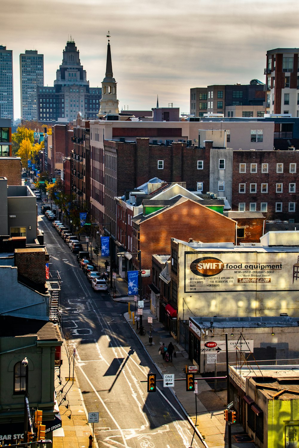 a city street filled with traffic and tall buildings