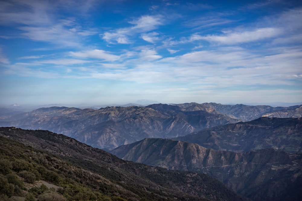 a view of a mountain range with mountains in the background