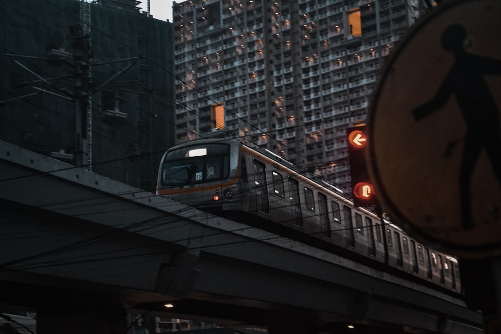 a train traveling through a city next to tall buildings