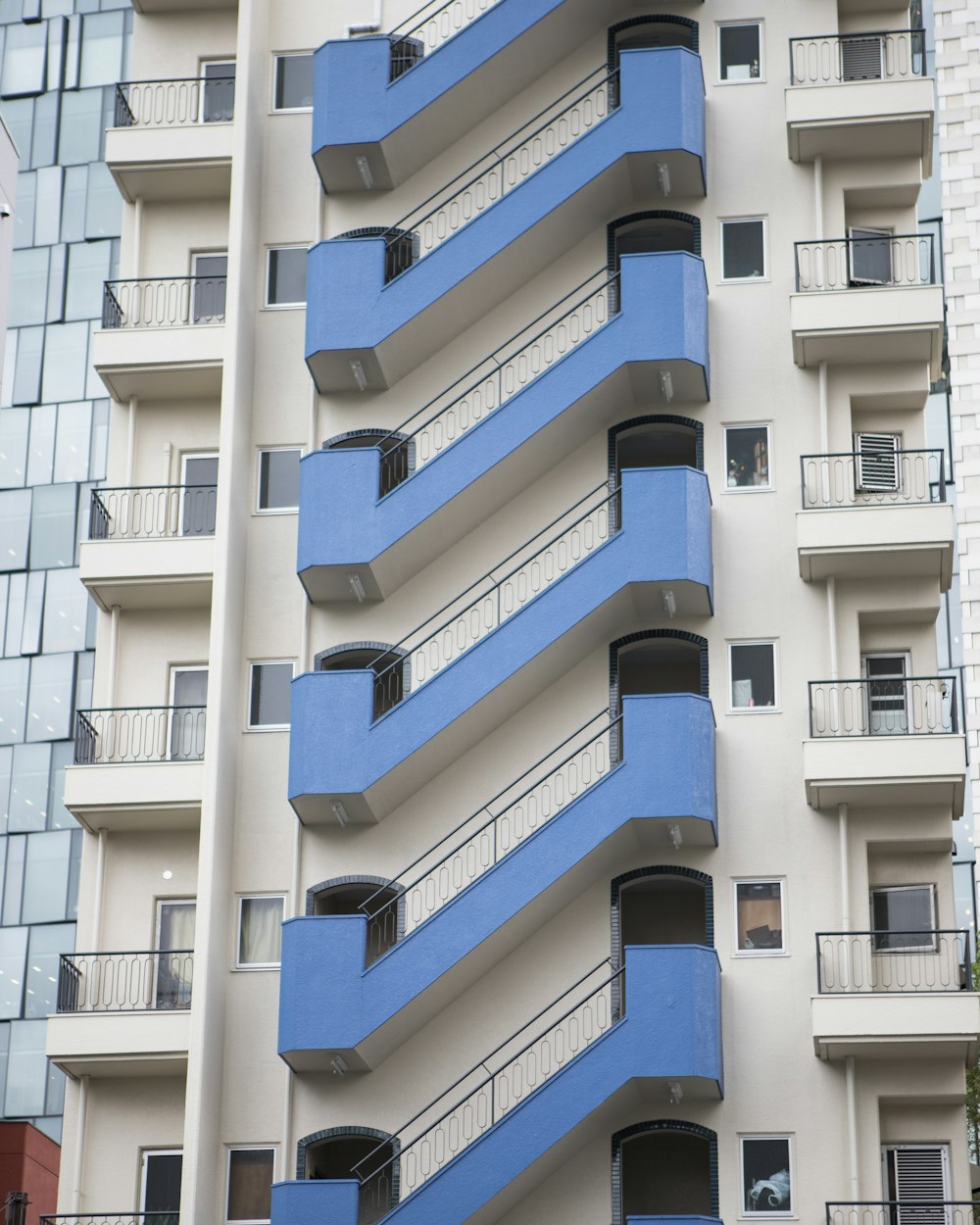 a blue and white building with balconies and balconies