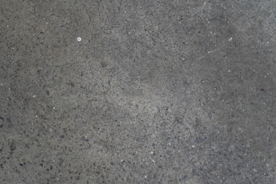 A repaired concrete driveway with a smooth, resurfaced finish.