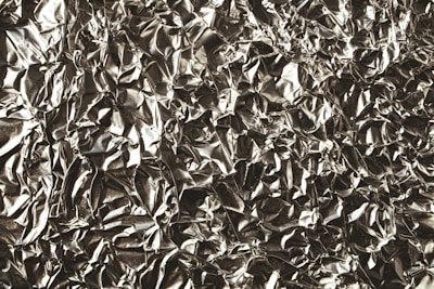 a black and white photo of a metal sheet