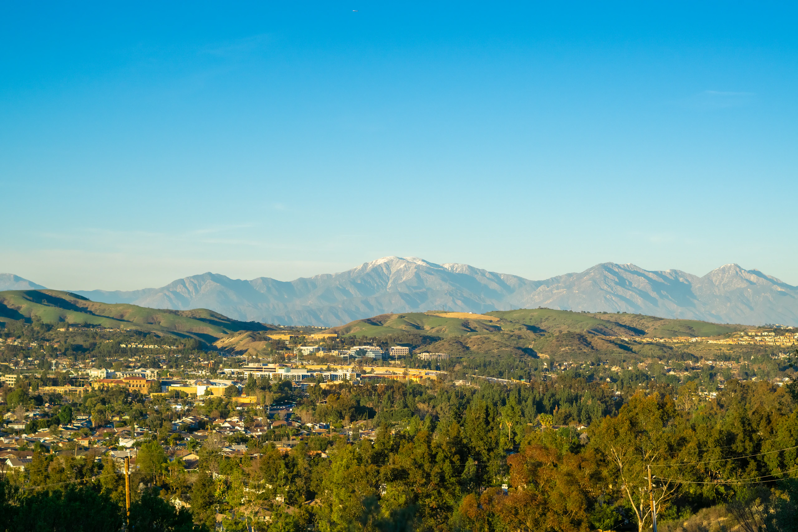 Colorado foothills with golden hills and distant mountains