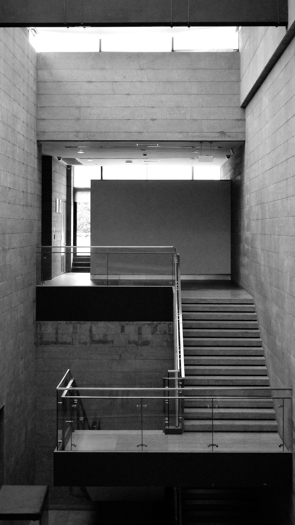 a black and white photo of a staircase in a building