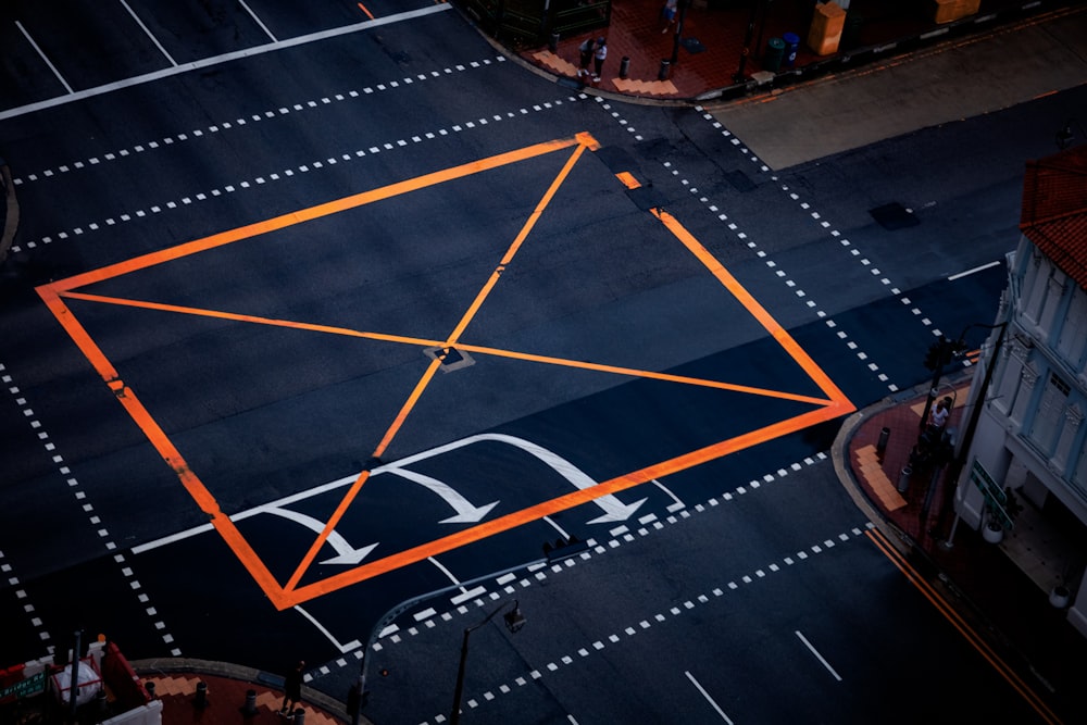 an aerial view of a parking lot with an orange triangle