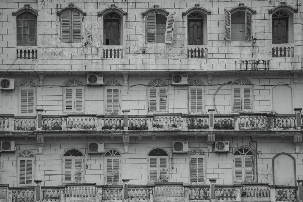 a black and white photo of a building with balconies