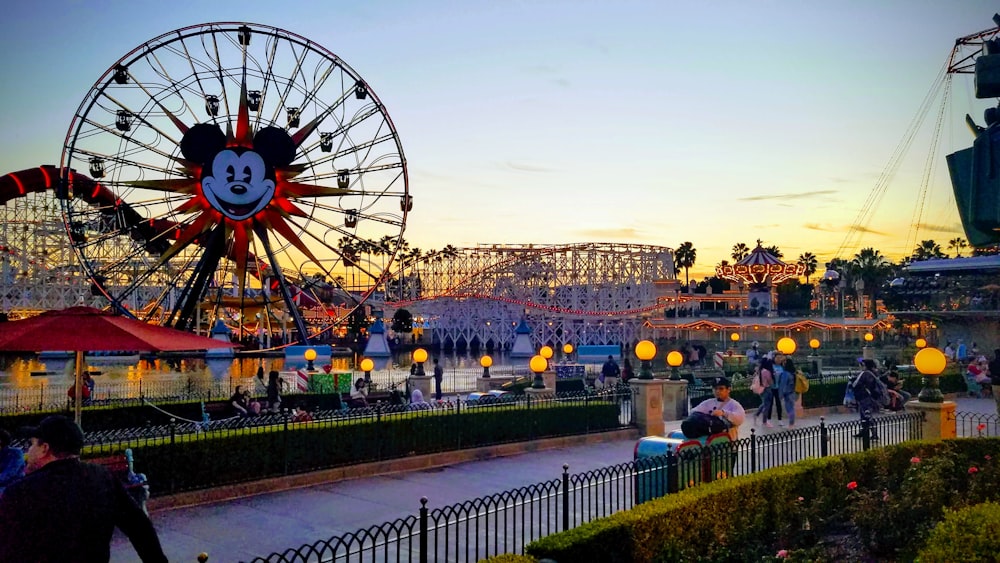 a ferris wheel and amusement park at dusk
