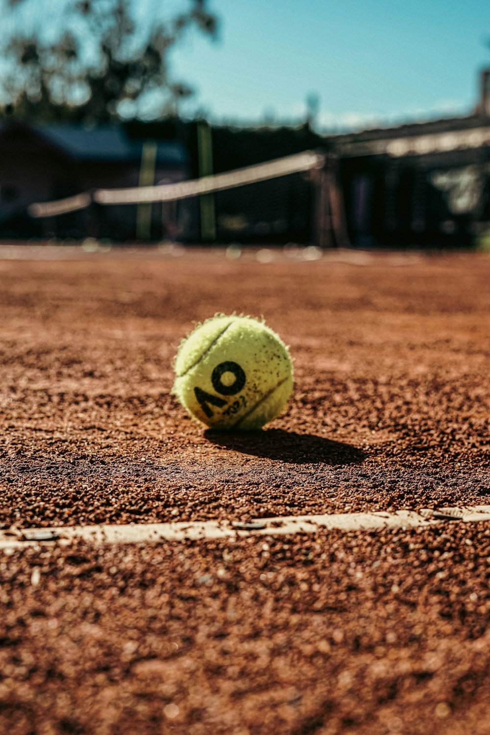 a tennis ball sitting on a tennis court