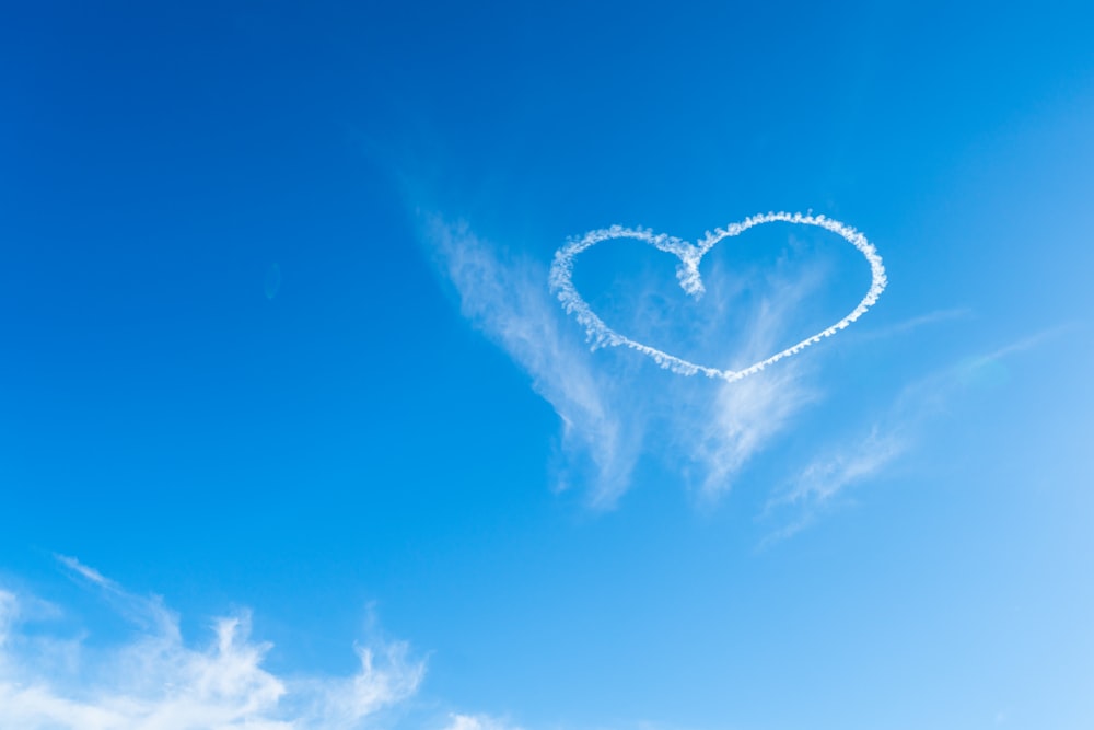 a heart shaped cloud in the blue sky