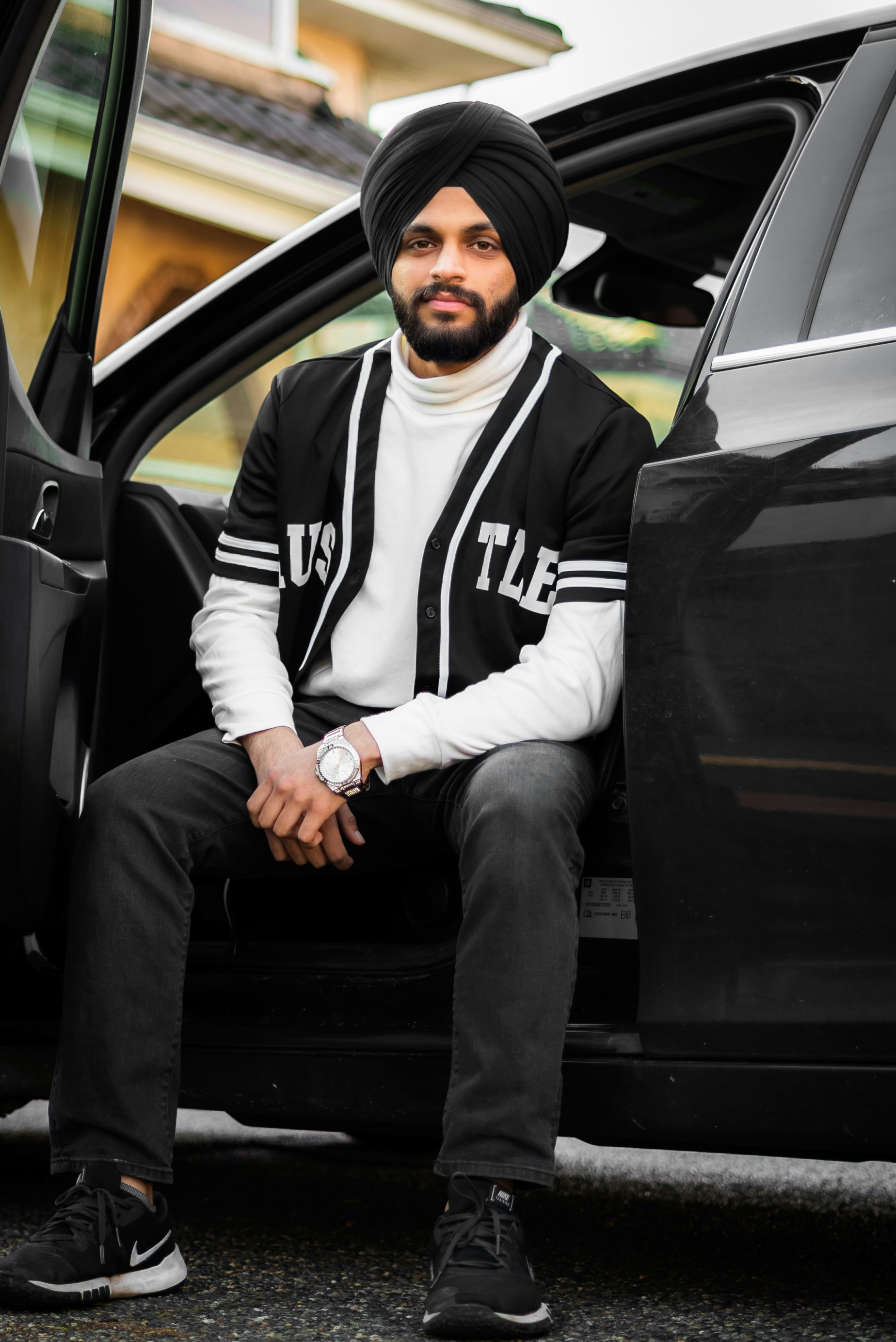 a man sitting in the door of a car