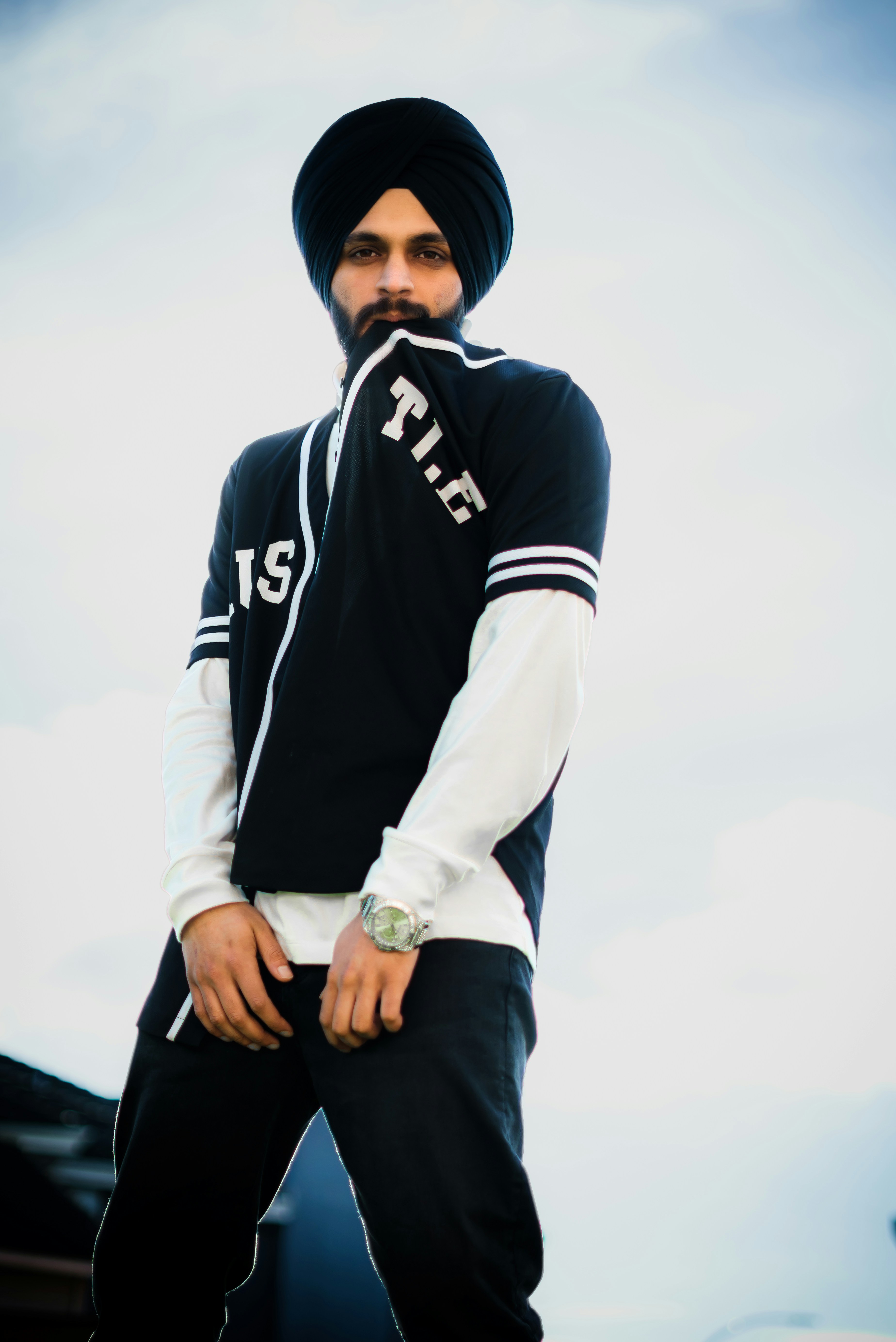 a man with a turban standing in front of a building