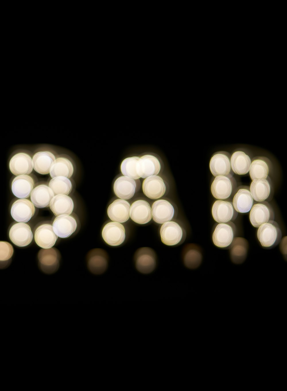 a blurry photo of a marquee sign in the dark