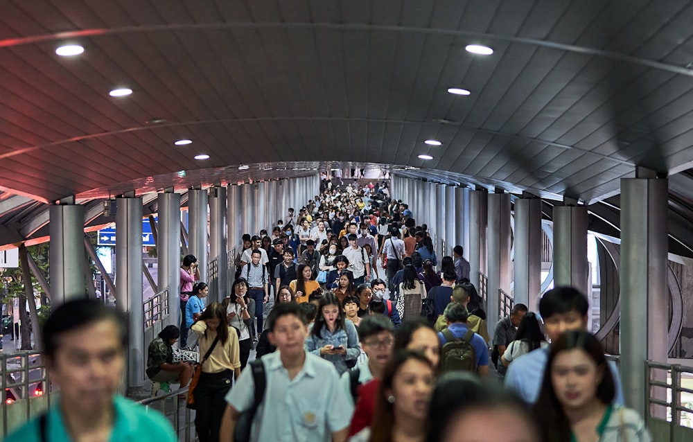 a group of people walking down a long hallway